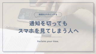 作業中に机のスマートフォンへ手を伸ばす様子